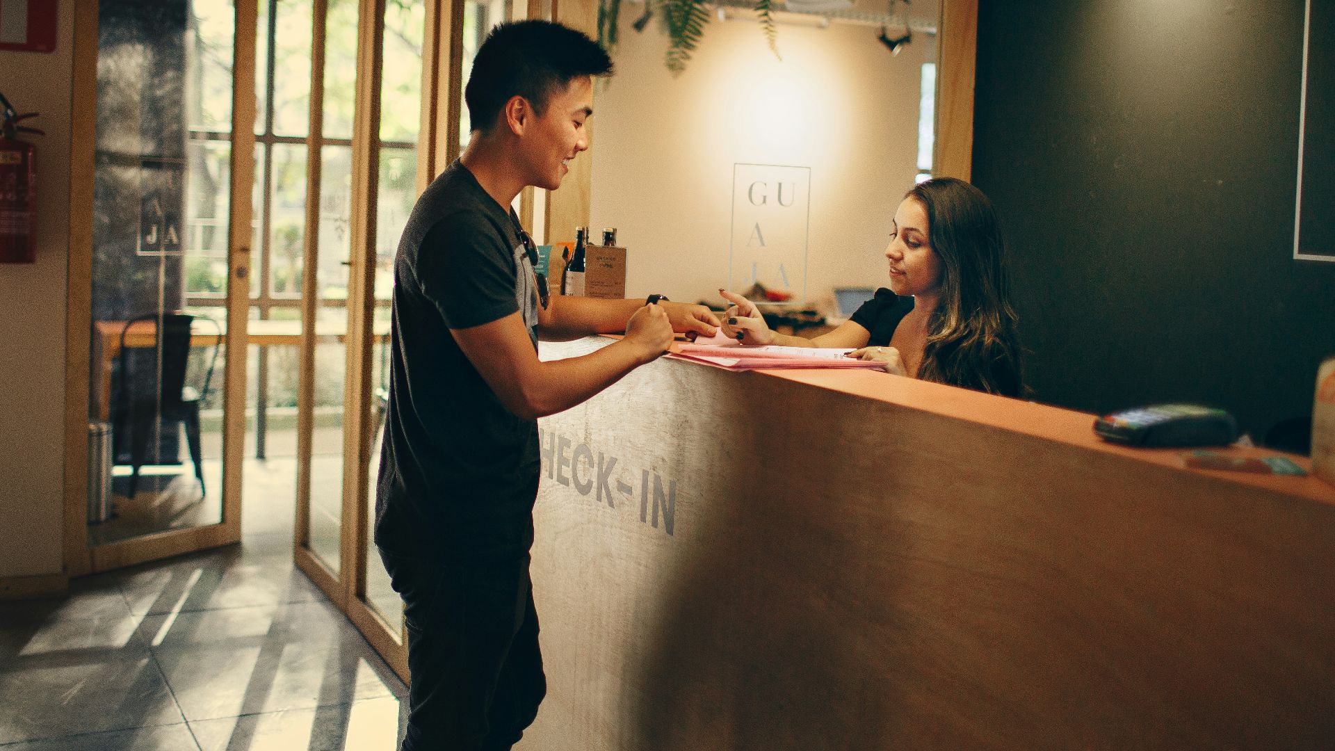man in black shirt standing beside counter