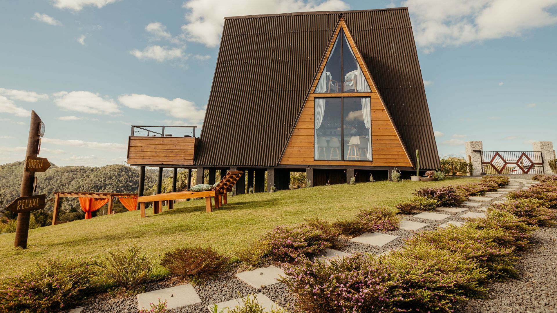 A cozy A-frame cabin in a scenic rural setting, perfect for relaxation and travel.