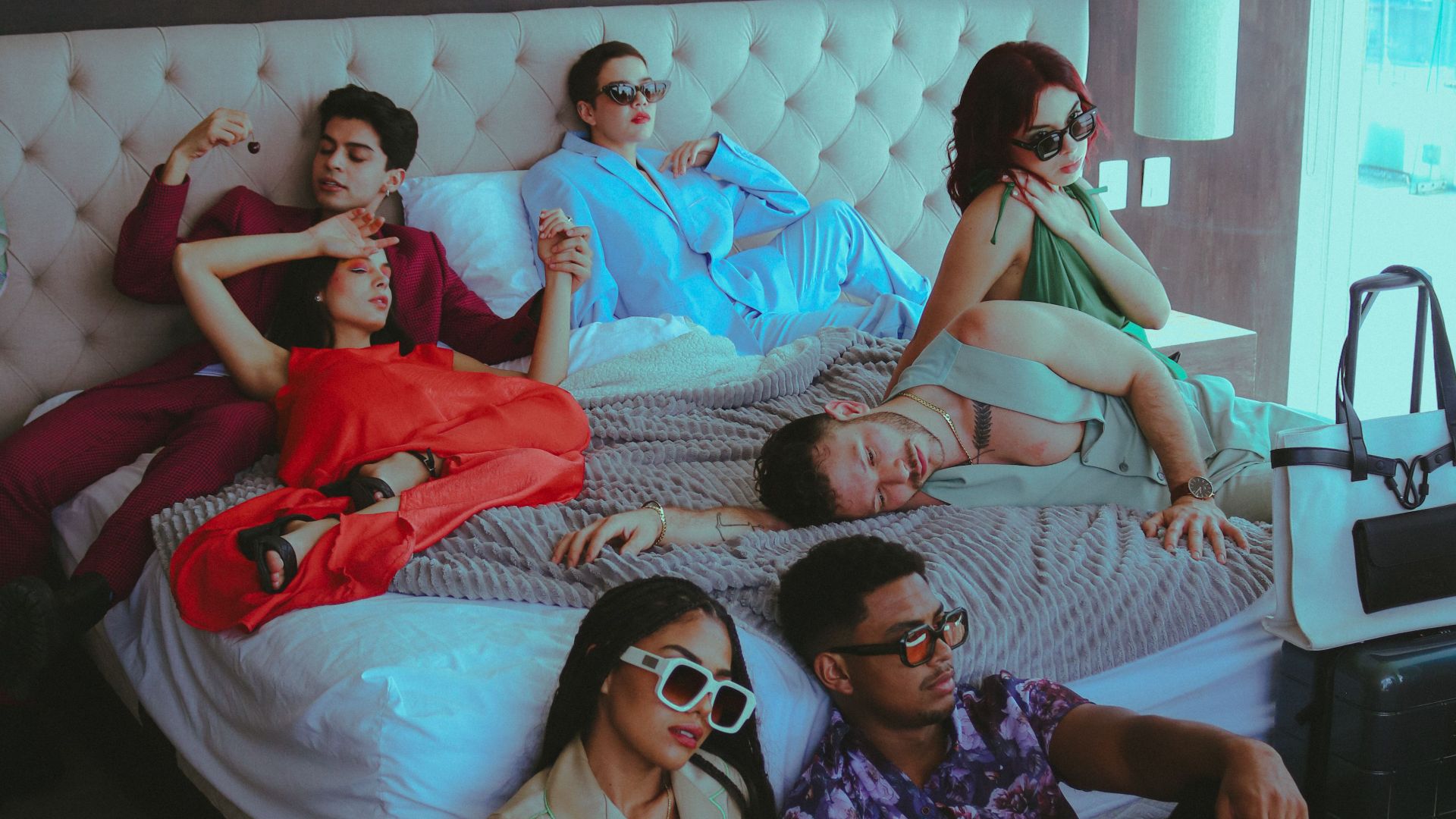 Stylish young adults lounging in a bright, modern hotel room. Urban lifestyle theme.