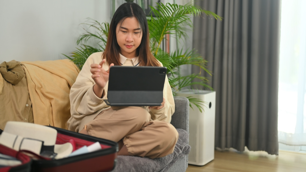 Young woman booking vacation trip