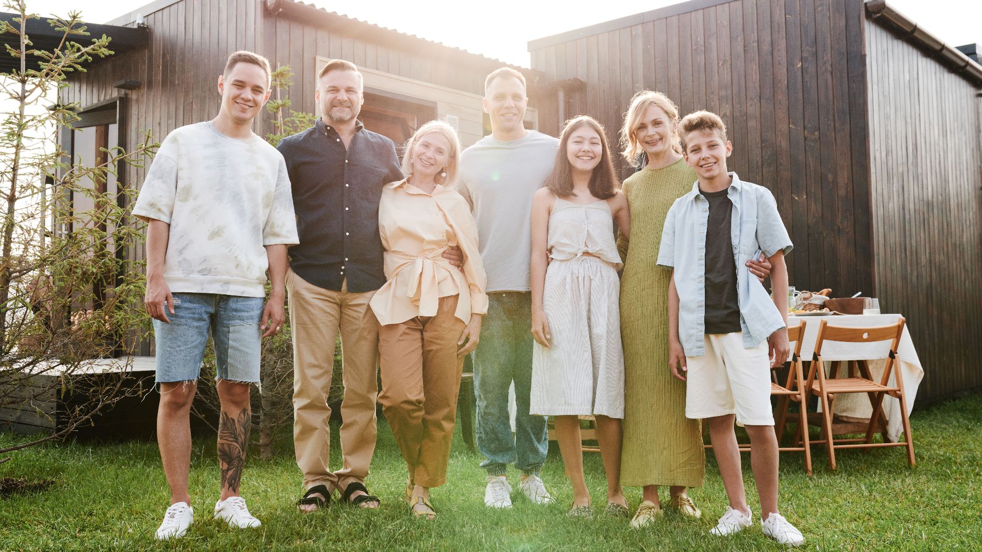 A joyful family posing together in a sunny outdoor setting, enjoying quality time.