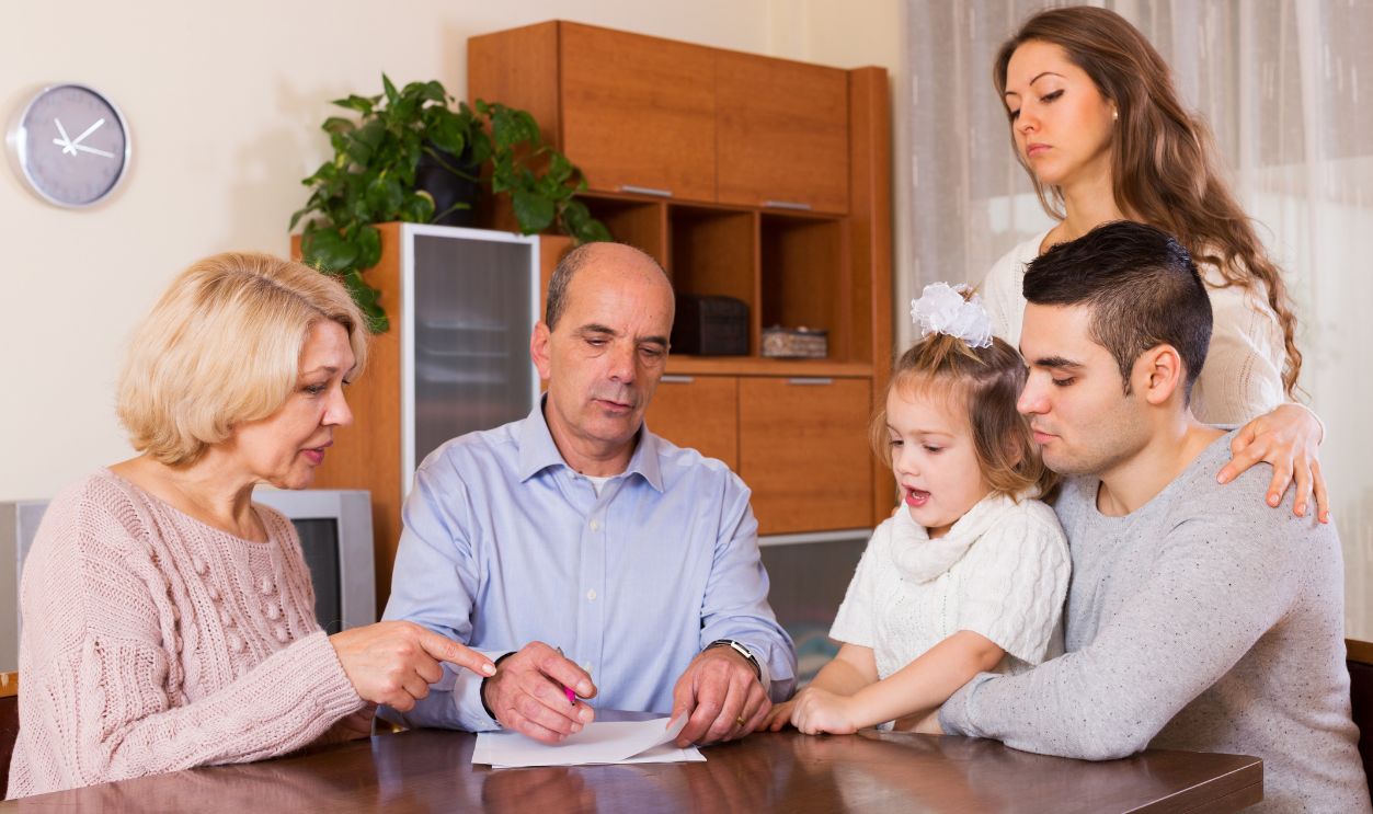 Shutterstock - 451829758 - Serious multigenerational family members with bills and without money at the table indoor.