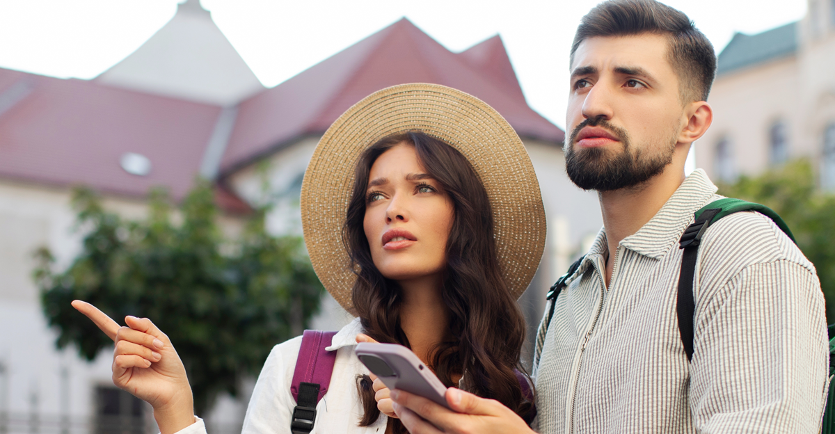 Worried couple using smartphone online maps at city center