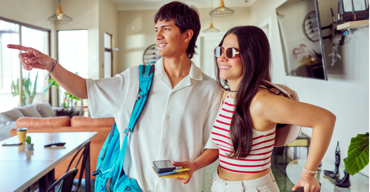 Young latin American couple arriving at small hotel for vacation