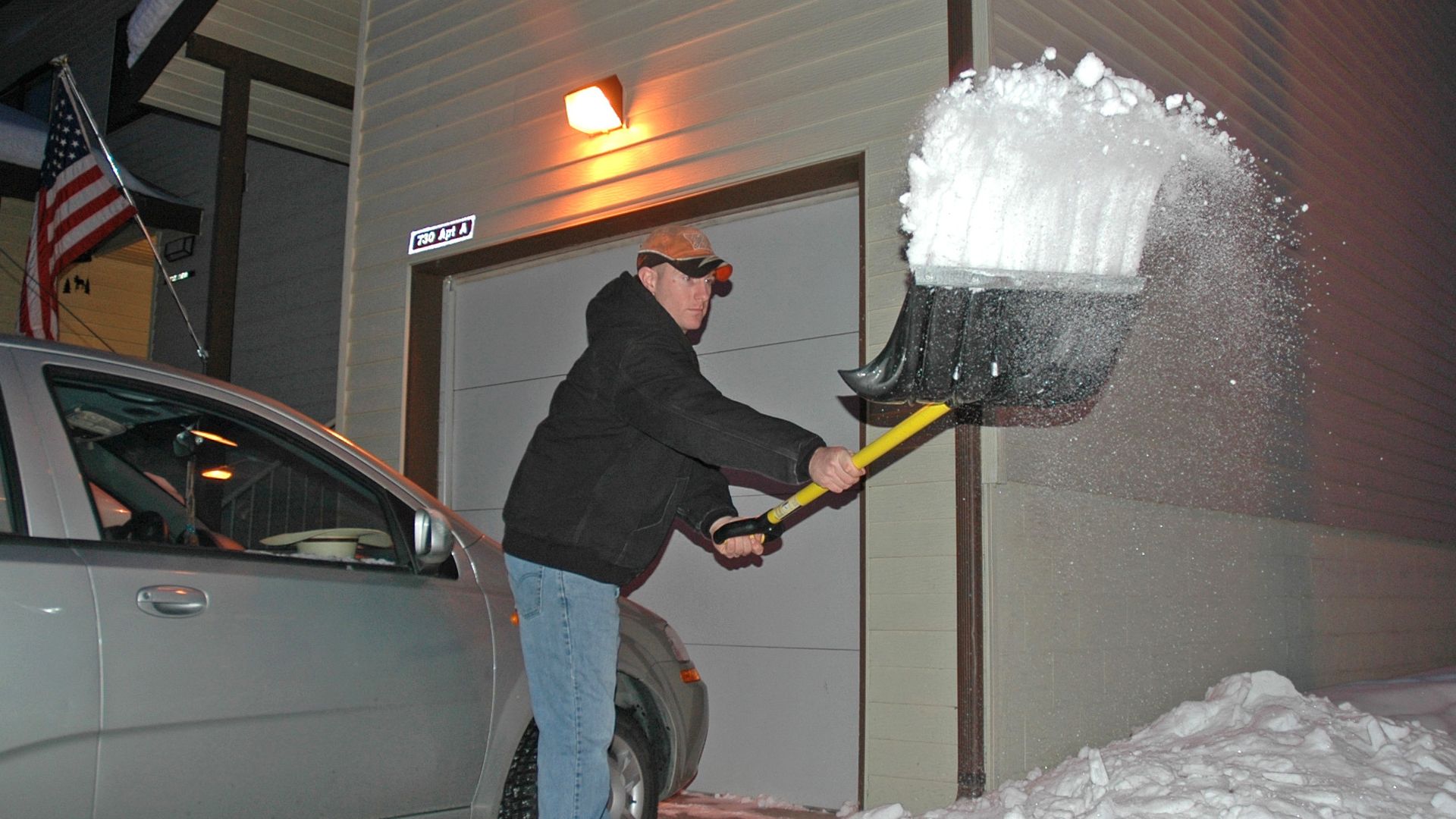 Staff Sgt. Phillip Bridges shovels the driveway of his new home