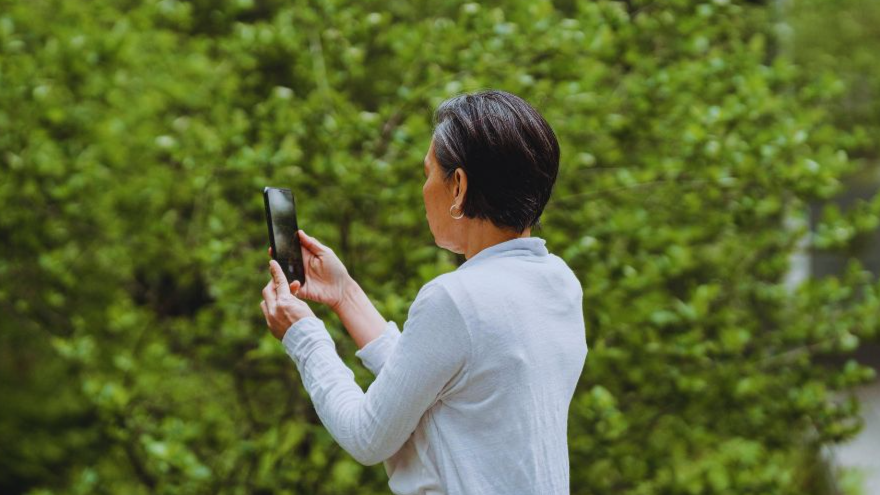 Woman Taking Photos Using Her Smartphone