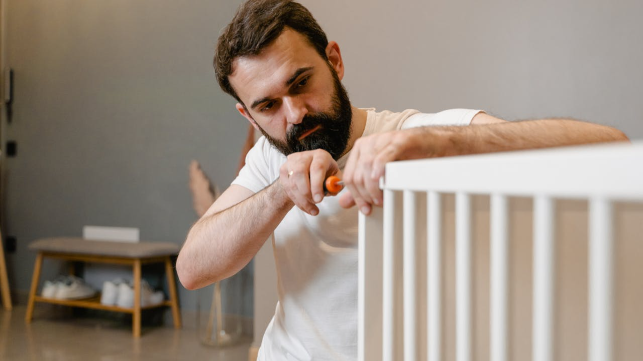 Man in White T-shirt Assembling Furniture