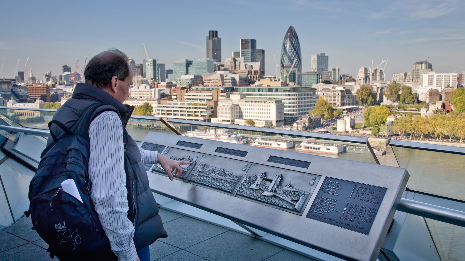 A man looks at the City of London skyline across the Thames from the London City Hall balcony. Taken by myself with a Canon 5D and 24-105mm f/4L IS lens.