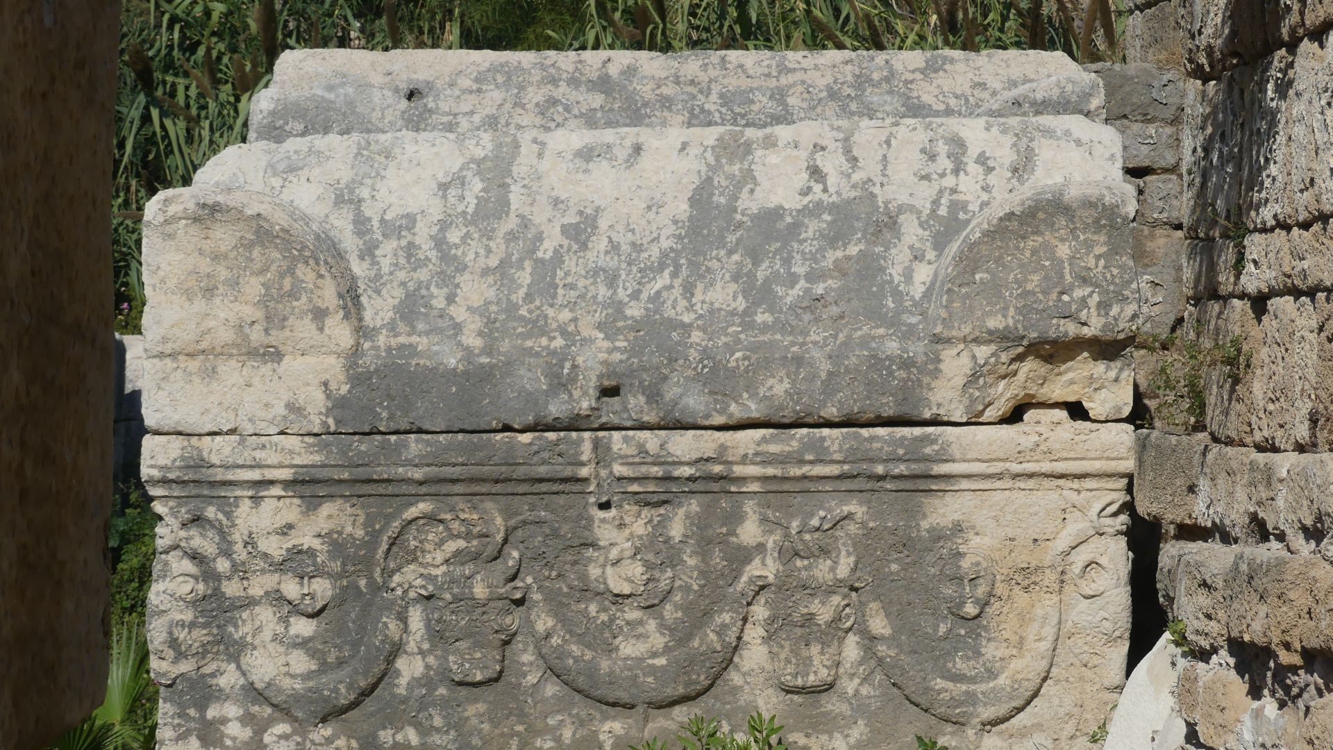Relief decorated with bull-heads, human faces, garlands and hearts fruit (grapes?) on an unfinished sarcophagus in the Roman necropolis of Al Bass / El Buss in Tyre/Sour, Southern Lebanon