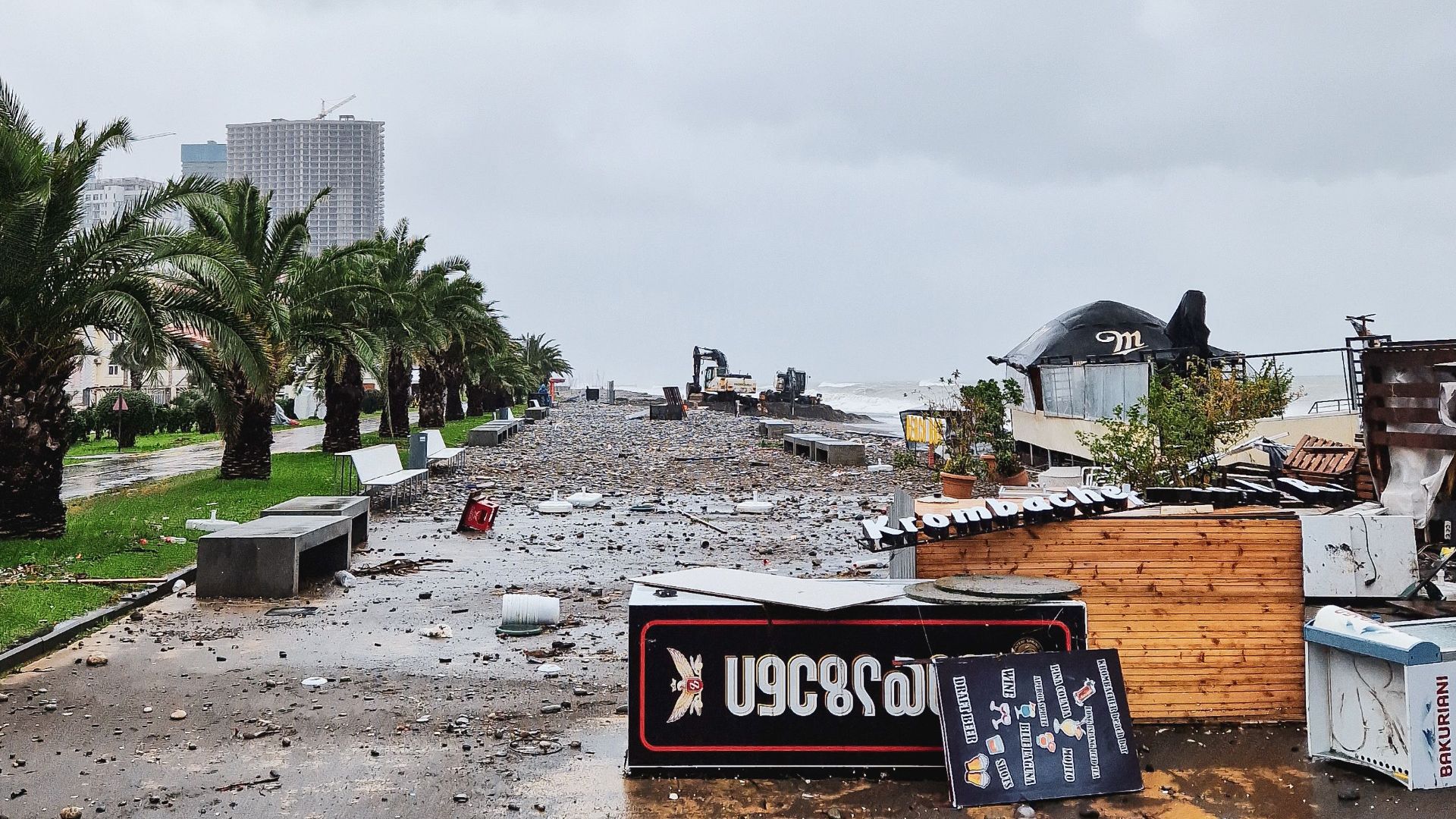 Destruction on a city street after a severe storm with fallen signs and debris