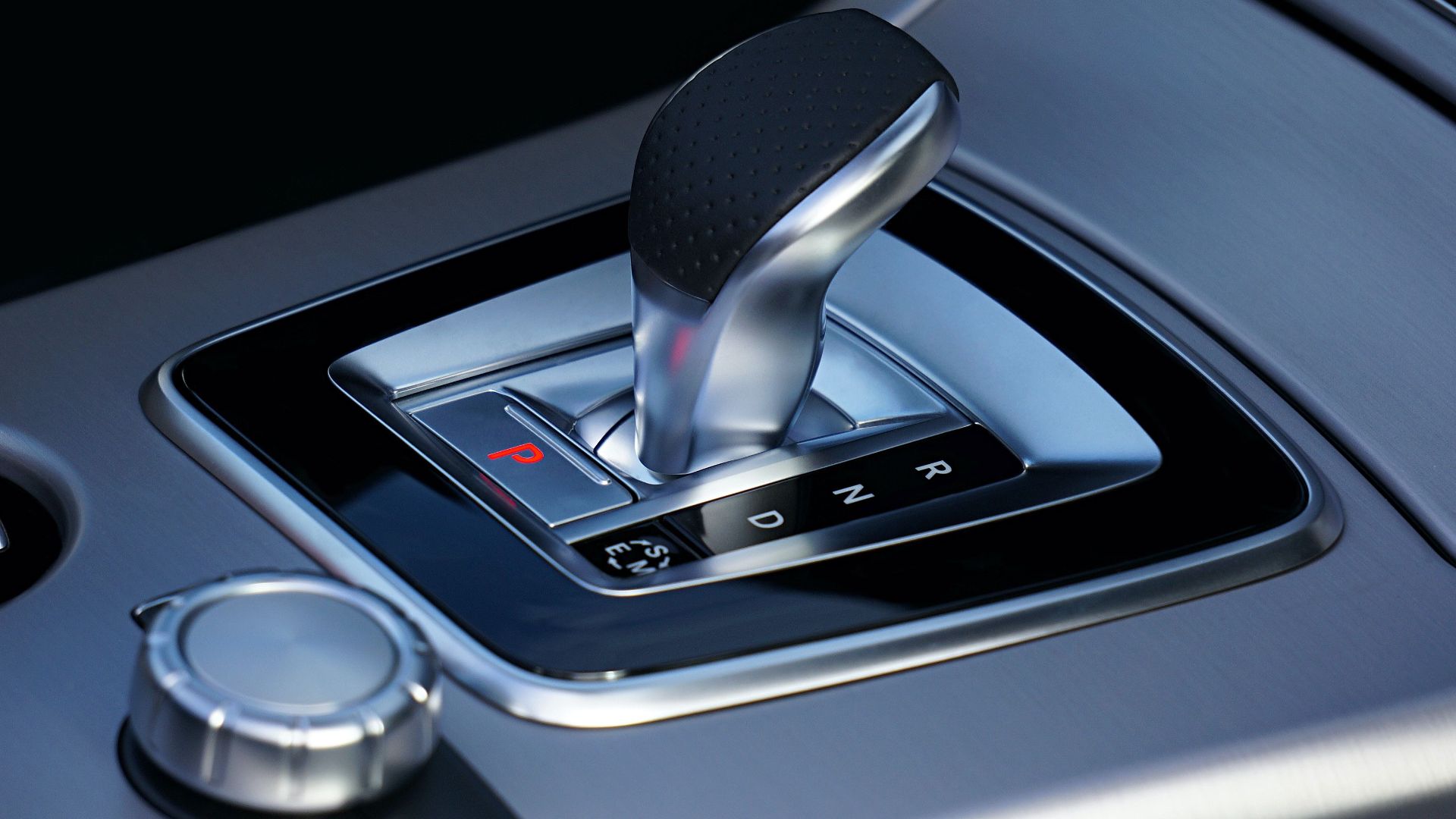 Detailed view of a sleek automatic gear shift in a luxury vehicle, emphasizing modern design.