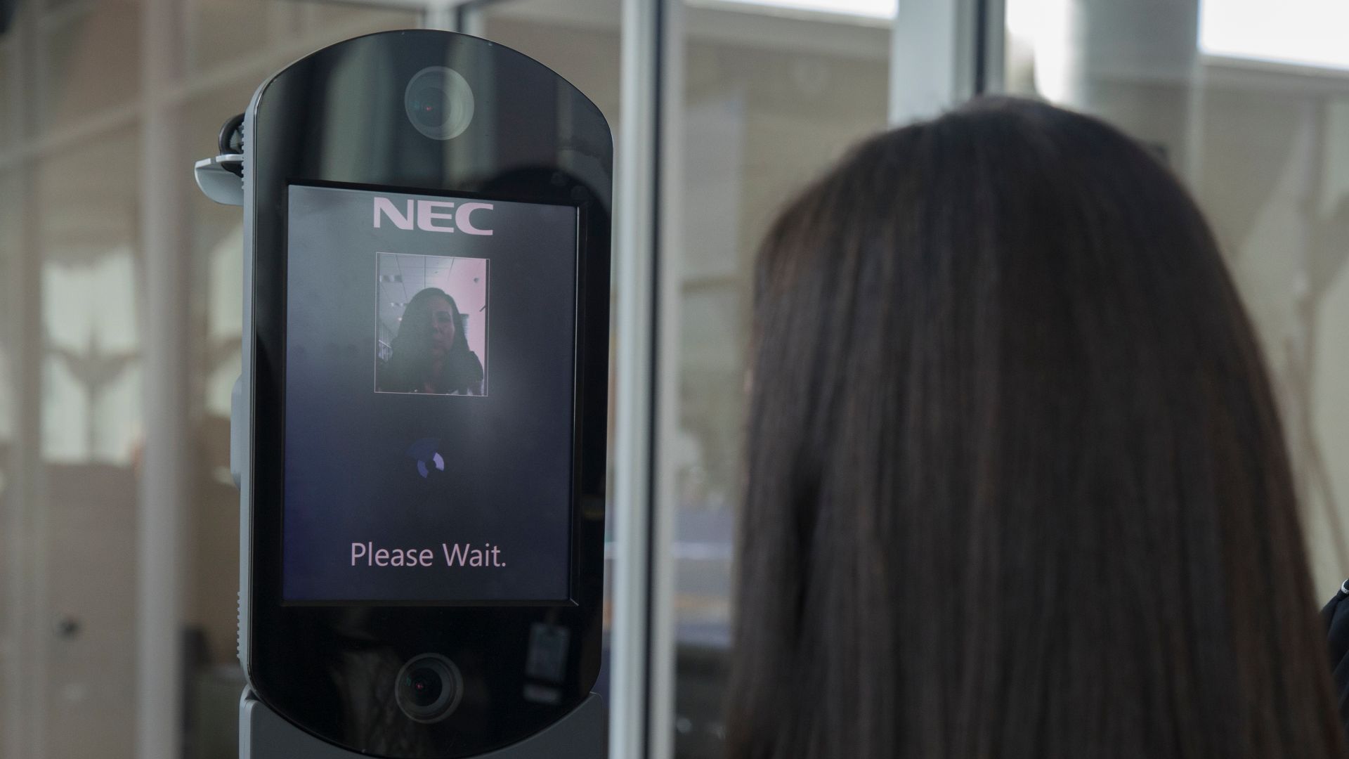 U.S. Customs and Border Protection, Office of Field Operations, officer takes biometric photos of passenger prior to boarding a flight at William P. Hobby Airport in Houston, Texas on February 12, 2018. ..Photographer: Donna Burton