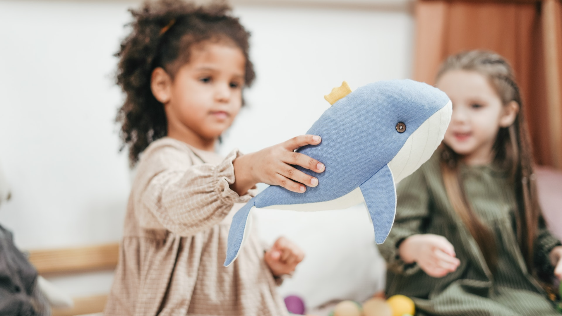 Girl playing at daycare with toys and children
