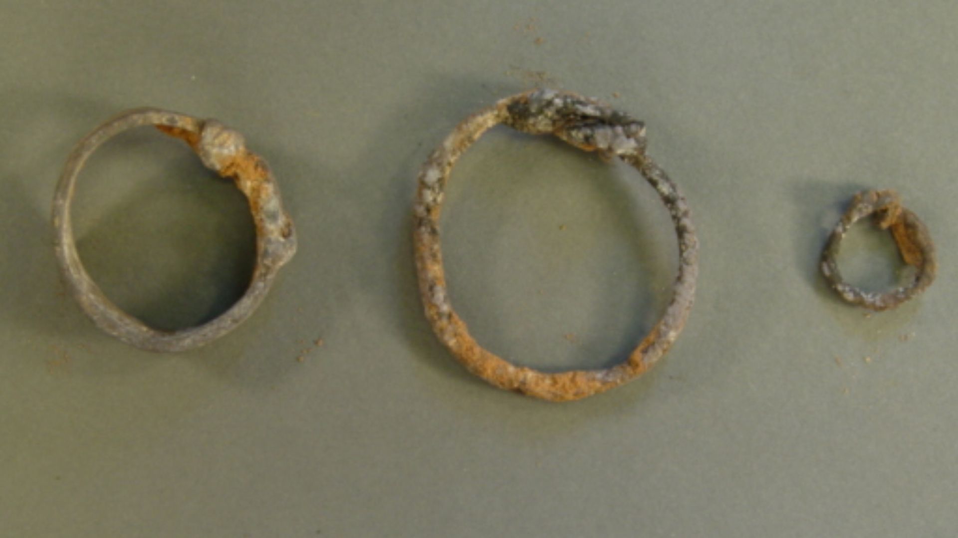 Three silver rings from Cumwhitton burial (grave 24)
The precious metal finds from the grave comprise three heavily corroded silver rings. Surface metal analysis conducted at the British Museum indicated an approximate silver content for them of 97%. The 