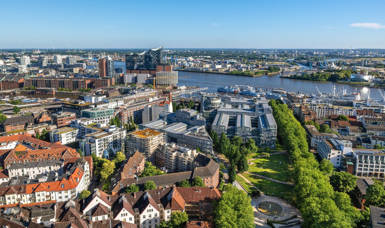 Hamburg, Germany - June 30, 2025: Aerial view of a cityscape of Hamburg, modern buildings, parks, Elbe river. The scene captures urban life with a mix of residential and commercial areas.