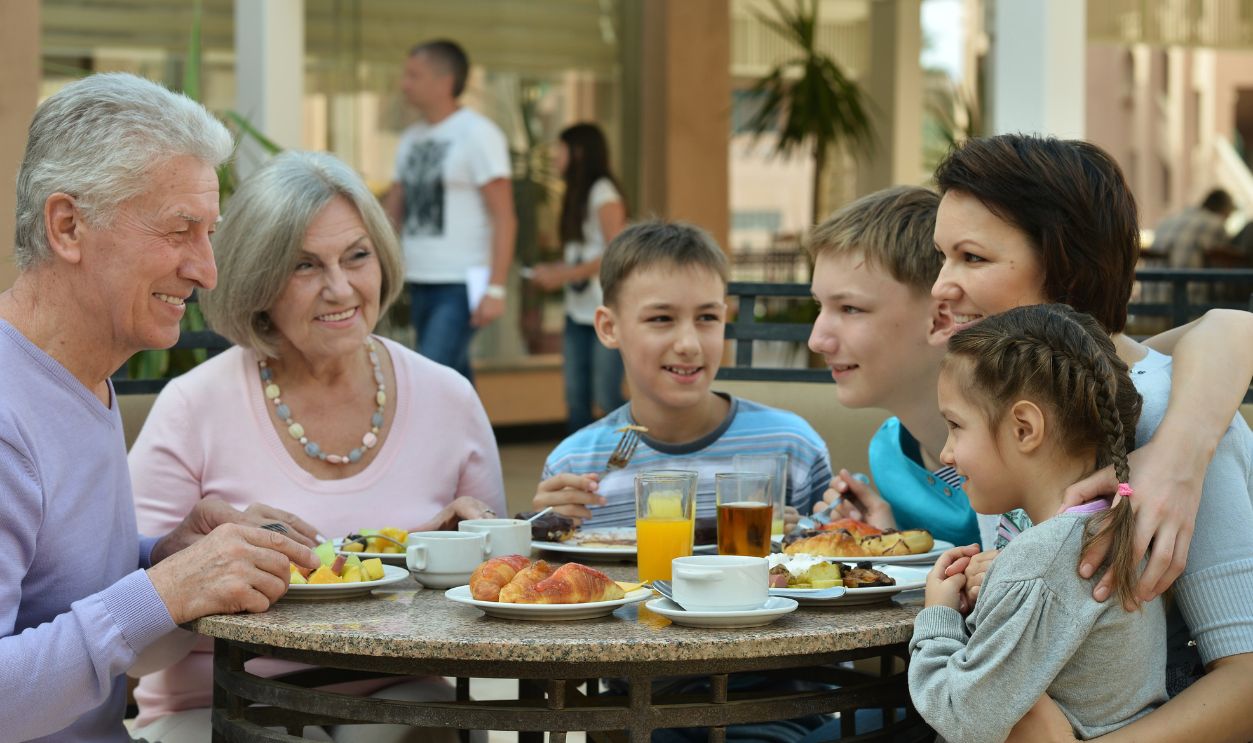 Happy family at breakfast on tropical resort