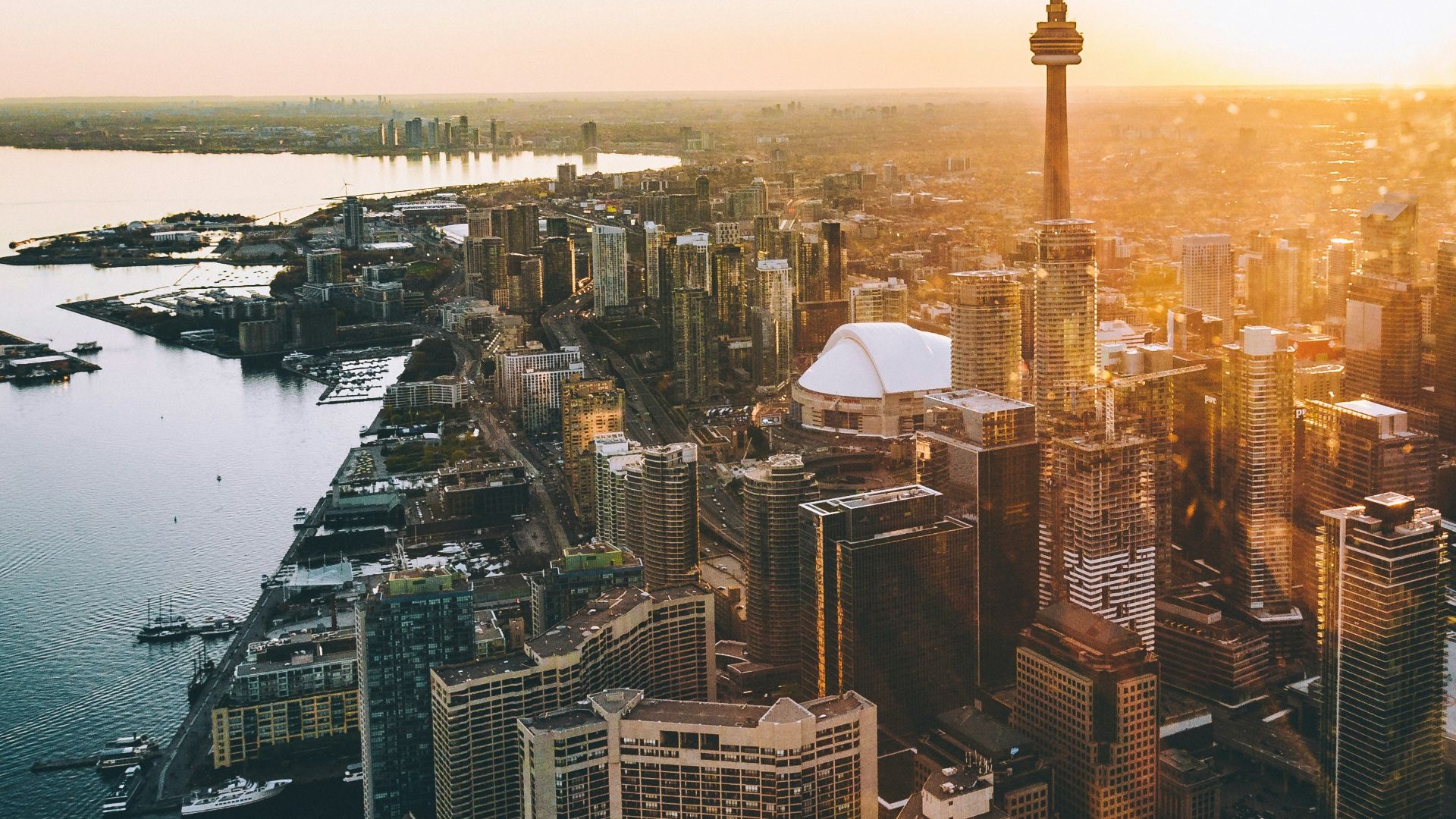 An aerial view of the CN Tower and downtown Toronto skyline at golden hour