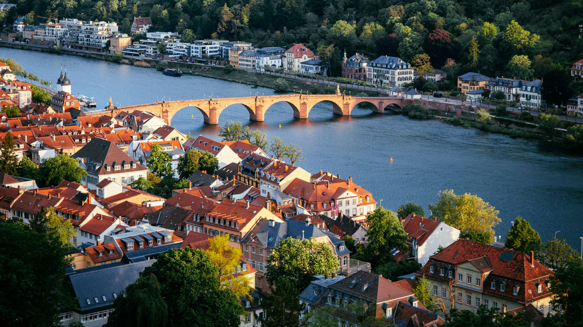 The Old Bridge spanning the Neckar River in Heidelberg, Germany, surrounded by historic buildings