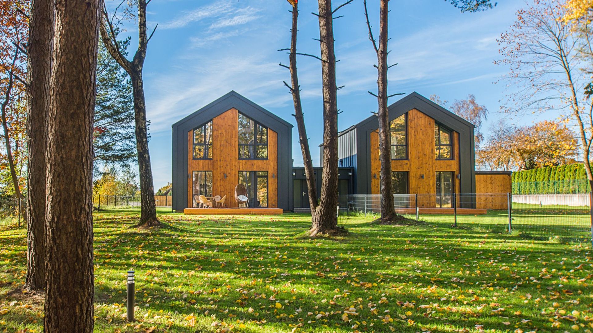 Modern architecture amidst vibrant fall landscape with colorful foliage.