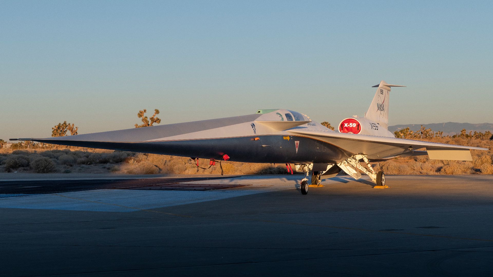 NASA’s X-59 quiet supersonic research aircraft sits on the ramp at Lockheed Martin Skunk Works in Palmdale, California during sunrise, shortly after completion of painting. With its unique design, including a 38-foot-long nose, the X-59 was built to demon