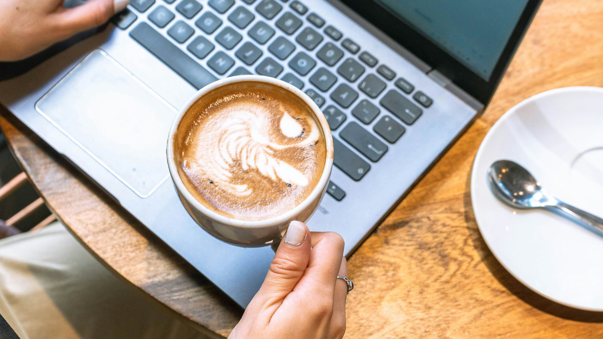 Working on a laptop with a coffee nearby
