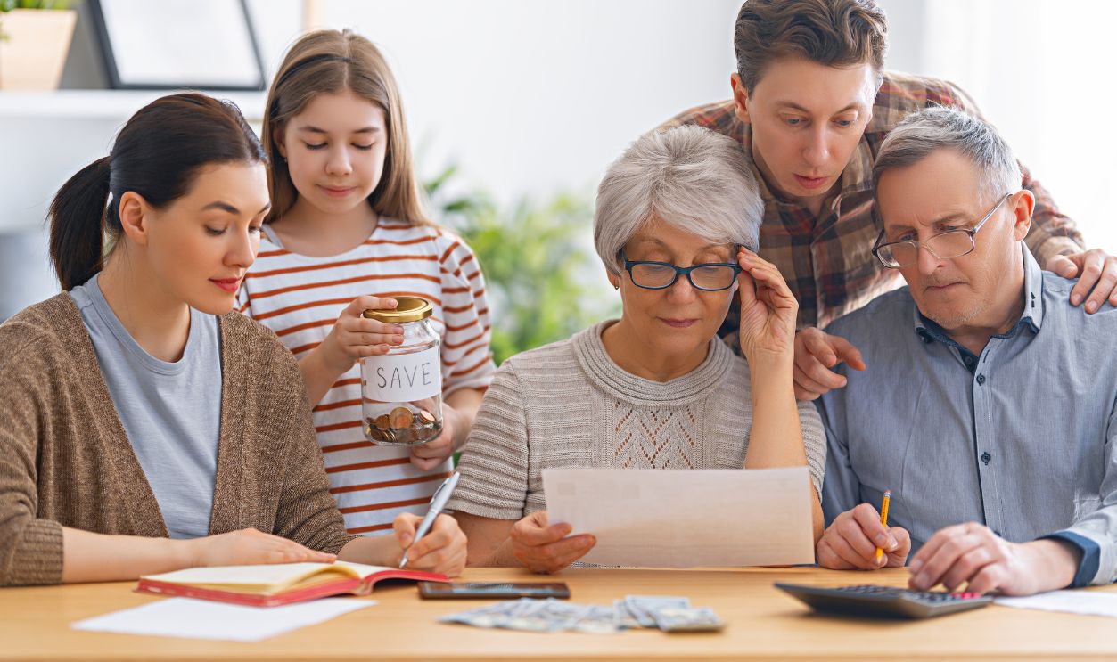Family are sitting at a desk with a paper receipt and calculating expenses, managing budget.