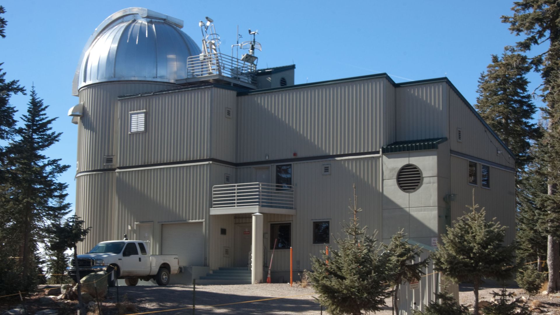 The Vatican Advanced Technology Telescope (VATT), the main telescope of the Vatican Observatory. The dome to the left houses the telescope itself; the space to the right are the control room and the living space for the observers.