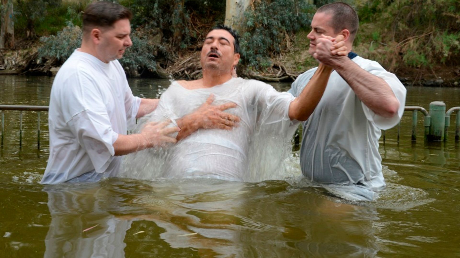 Sailors and Marines assigned to the amphibious transport dock ship USS Mesa Verde (LPD 19) are baptized during a tour to the Jordan River during a port visit. (U.S. Navy photo by Seaman Phylicia A. Hanson/Released)
