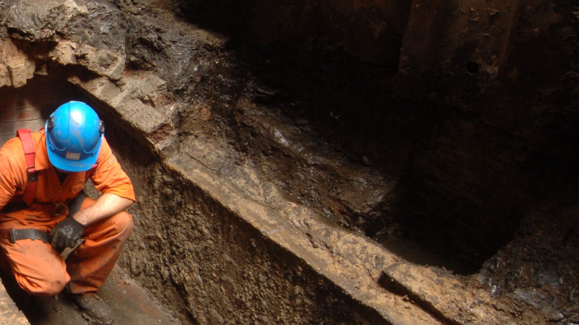 Archaeologist excavating a historic sewer at Liverpool Street Worksite, Liverpool Street (Crossrail XSM10)