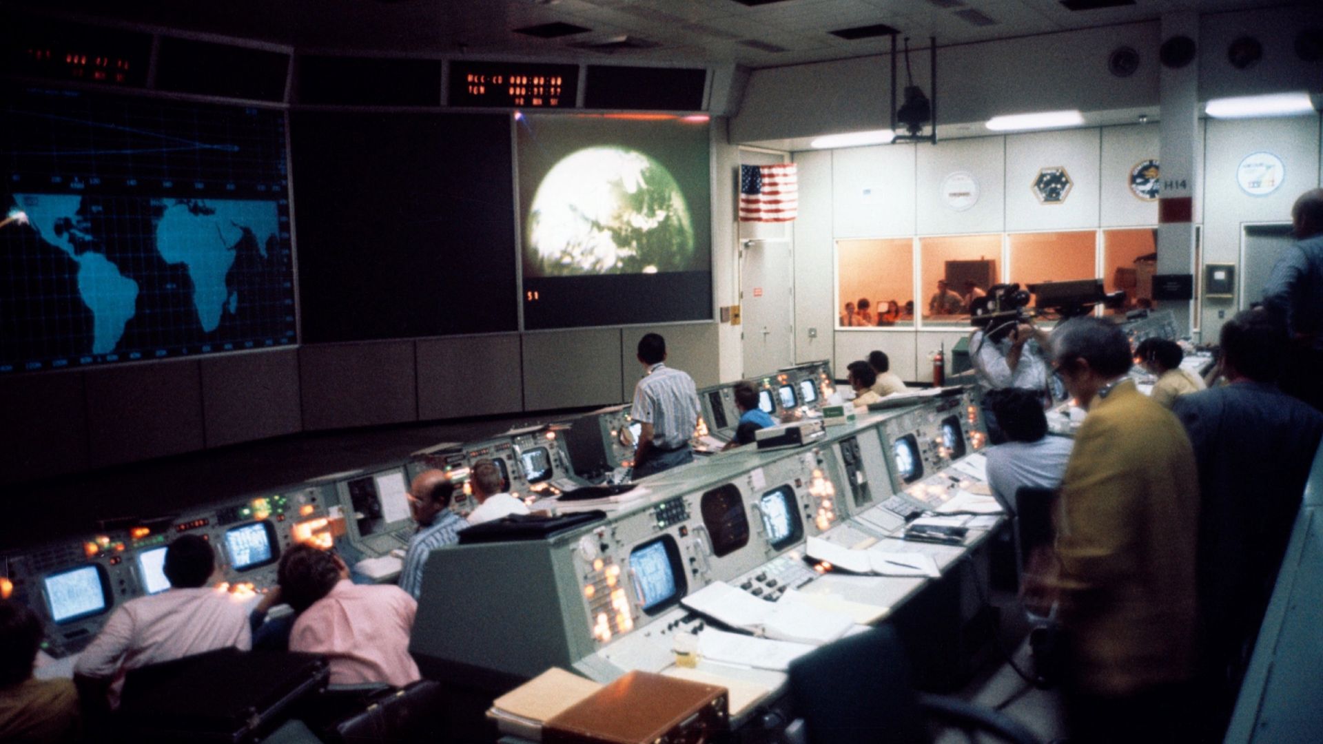 (April 16, 1972) An overall view of activity in the Mission Operations Control Room (MOCR) in the Mission Control Center (MCC) on the first day of the Apollo 16 lunar landing mission. This picture was taken during television coverage transmitted from the 