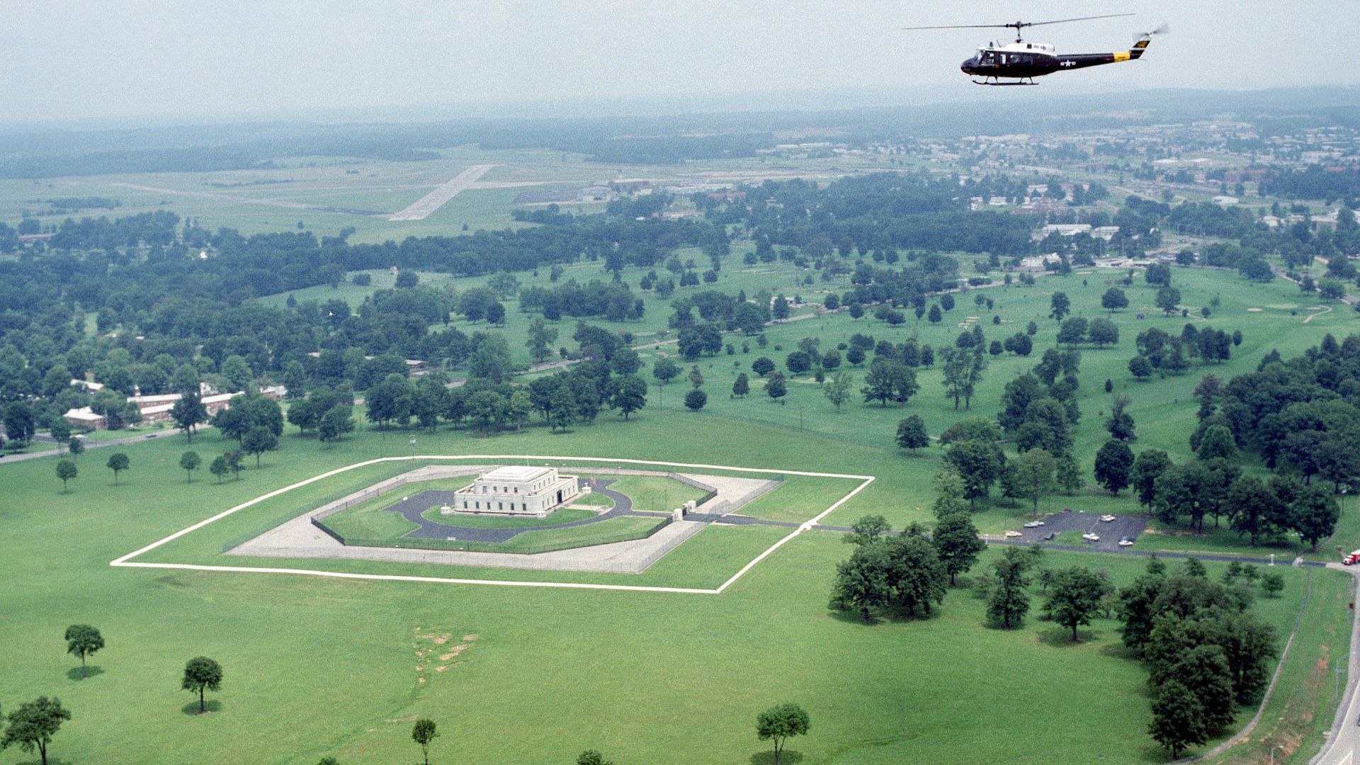 An UH-1 Iroquois helicopter flies over the US Gold Bullion Depositiory.