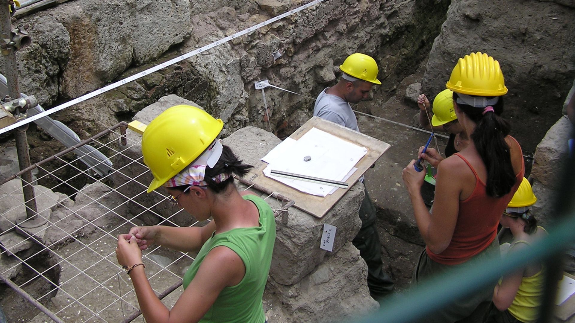 Excavations at the Roman Forum in Rome, Italy, are being mapped by these archaeologists. 

Photographed by myself (Adrian Pingstone) in June 2007 and placed in the public domain.