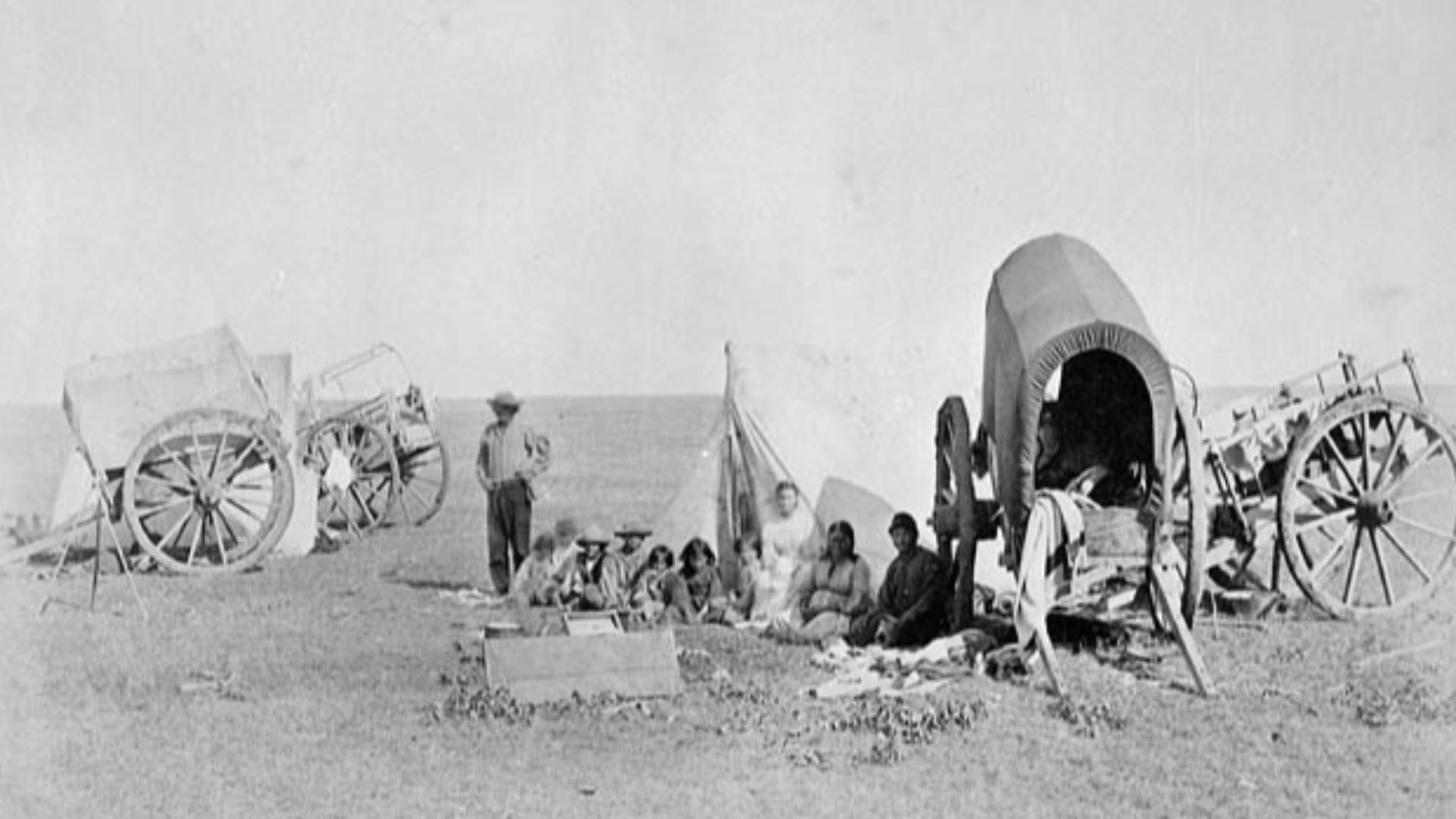 Camp scene of Métis people with carts on prairie. Manitoba, Canada