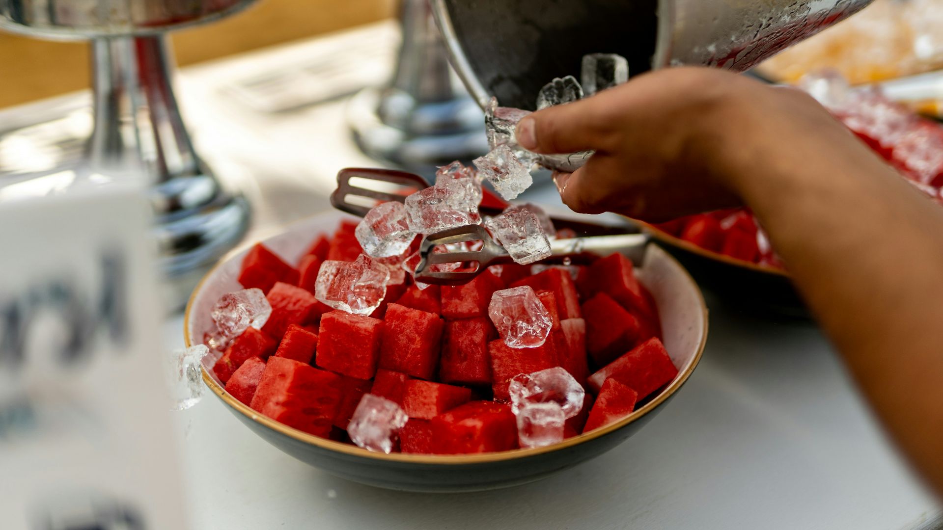 a person pouring a bowl of water