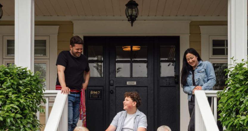 A diverse family enjoying quality time together on a porch, showcasing warmth and community