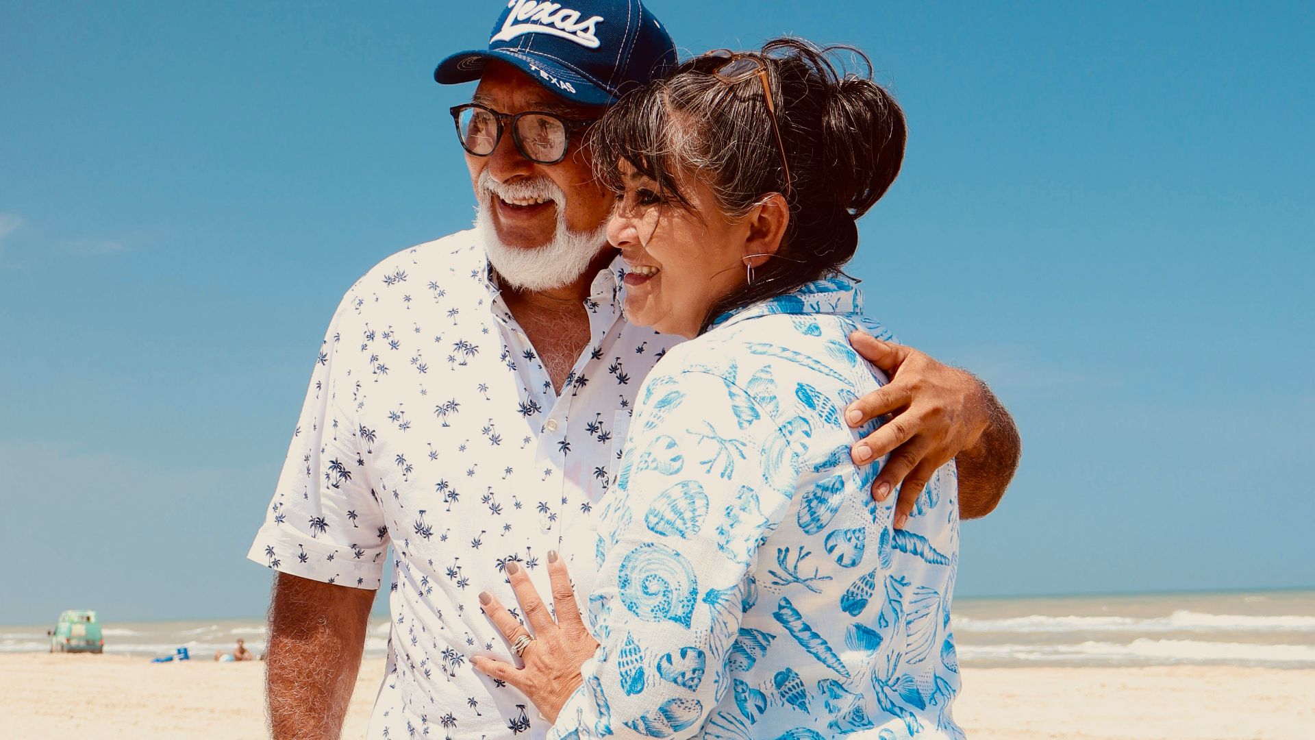Elderly couple embracing on a sunny beach