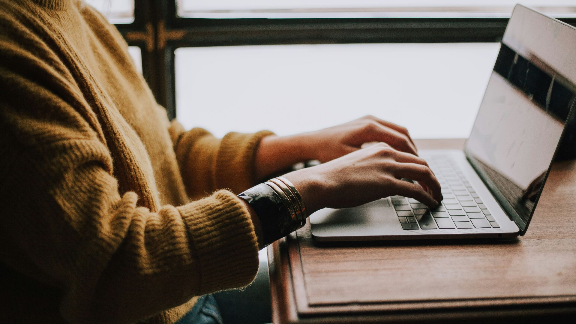 person sitting front of laptop