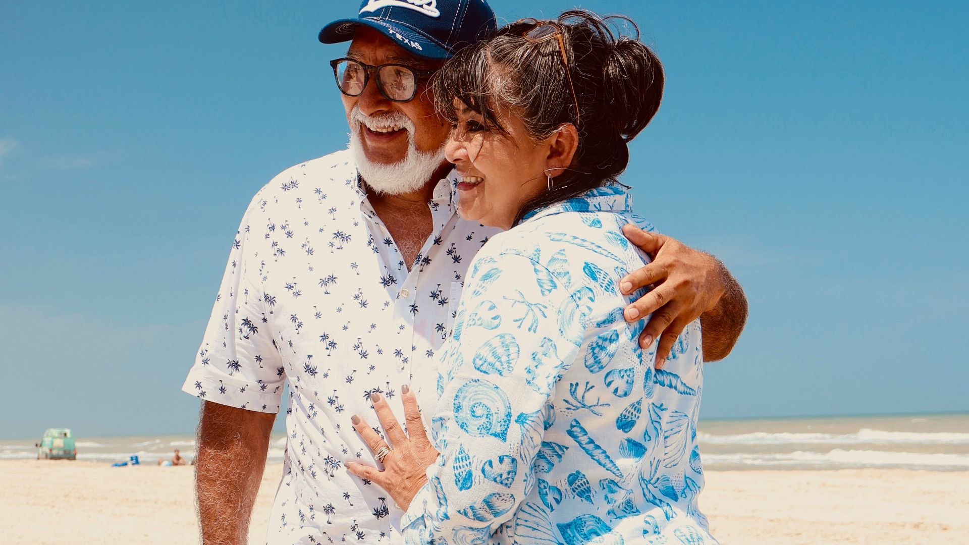Elderly couple embracing on a sunny beach