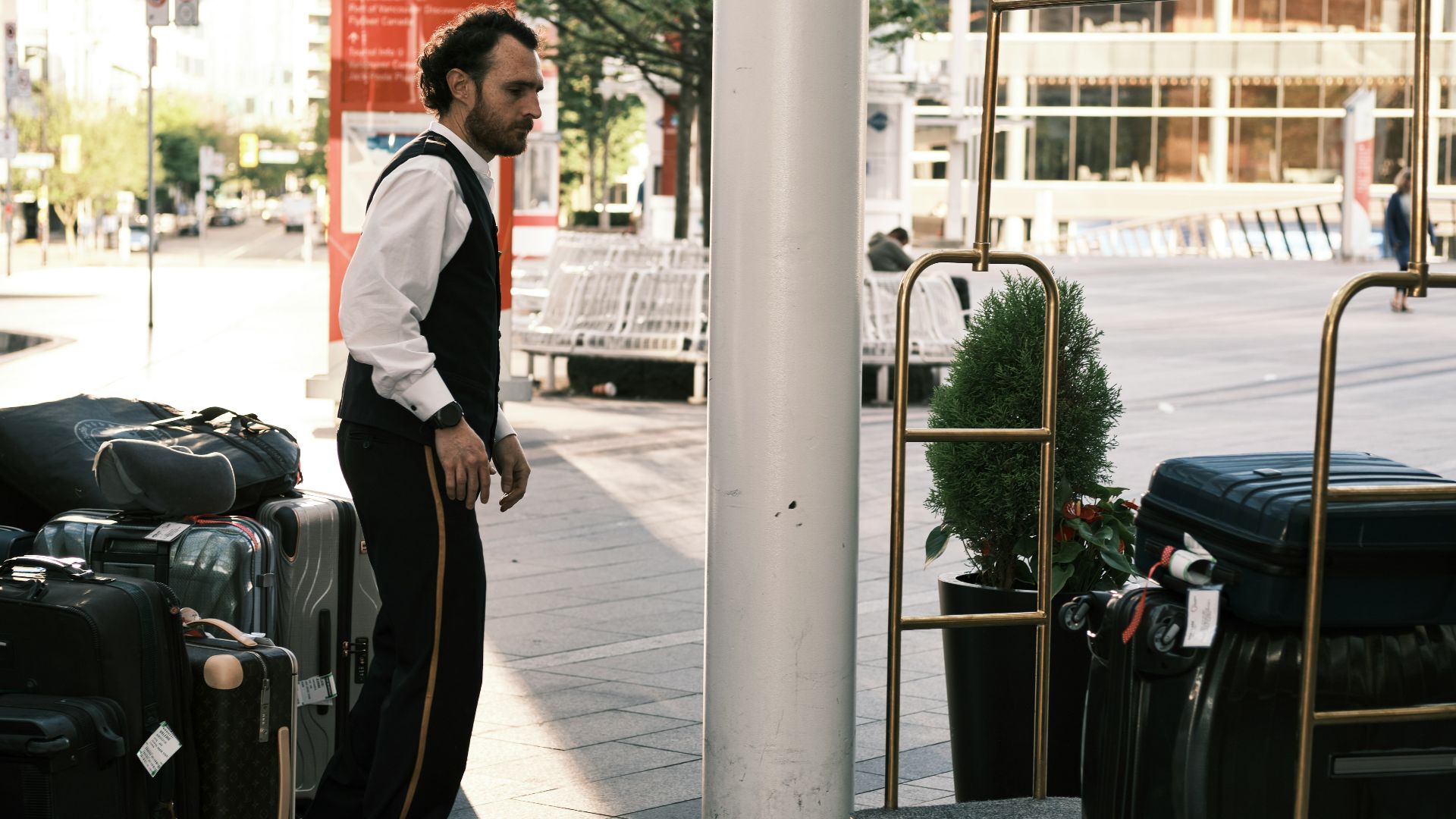 a man standing next to a pile of luggage