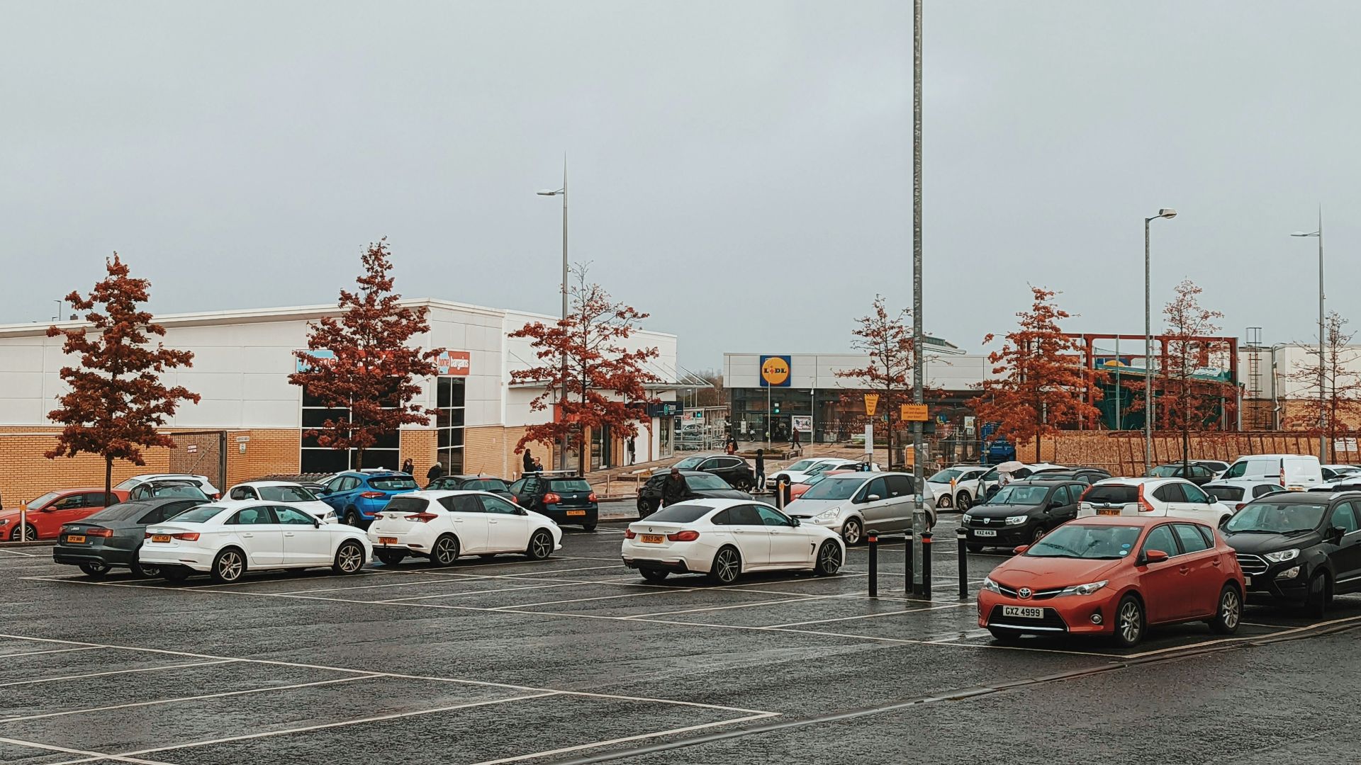 a parking lot filled with lots of parked cars