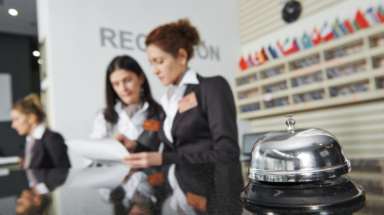 Shutterstock-228675523, Modern luxury hotel reception counter desk with bell