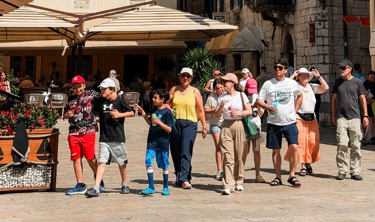 A group of tourists enjoy a sunny day in the historic town of Kotor, Montenegro