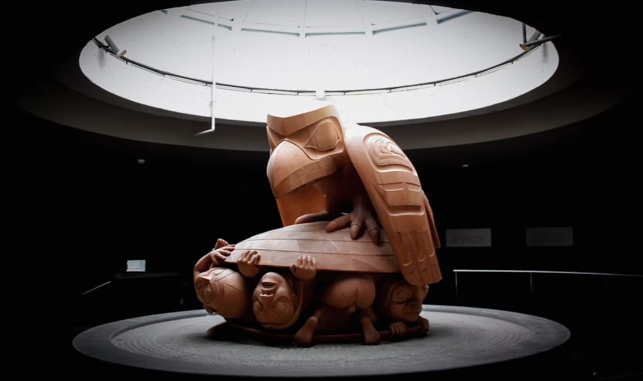 a sculpture of a person sitting on a bench