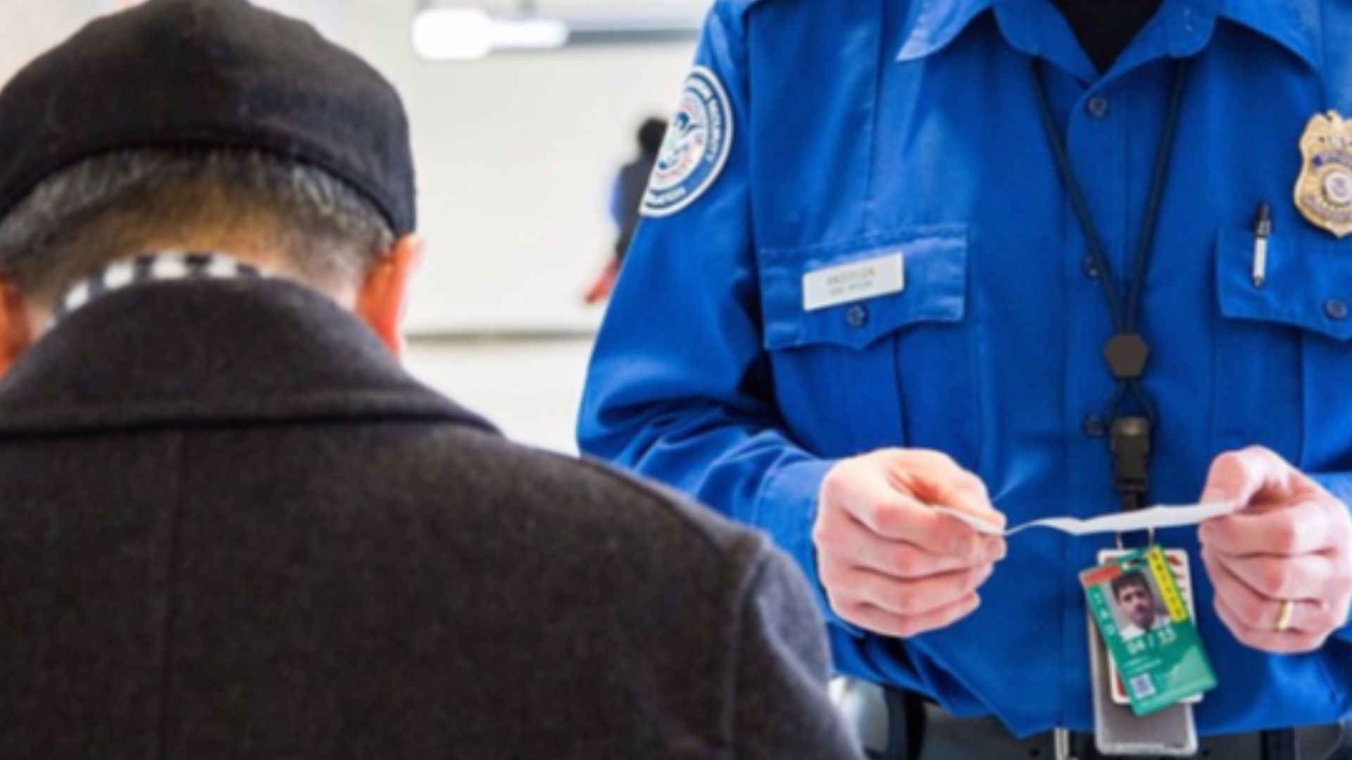 TSA officer checking a passenger's ID