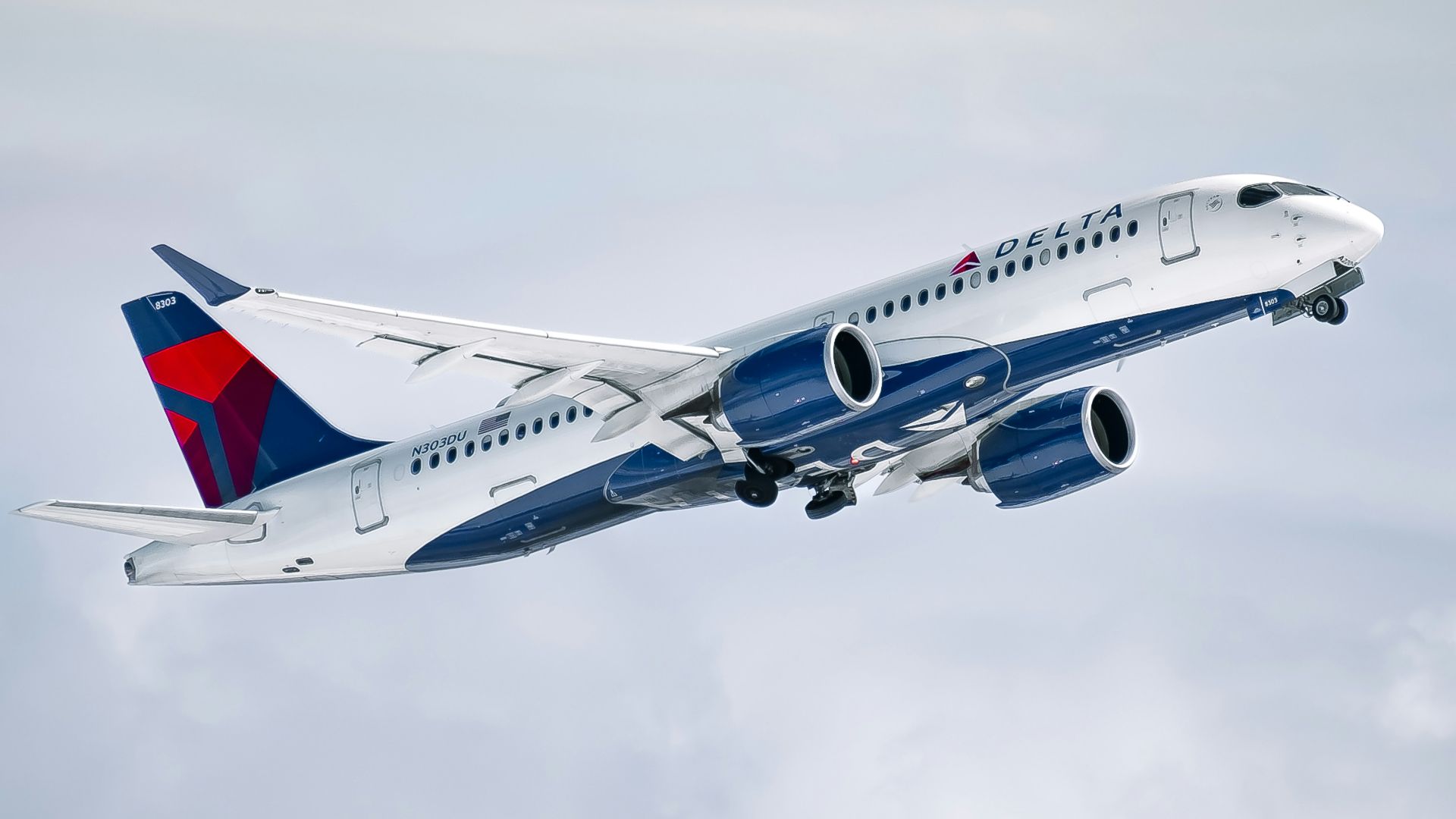 a large passenger jet flying through a cloudy sky