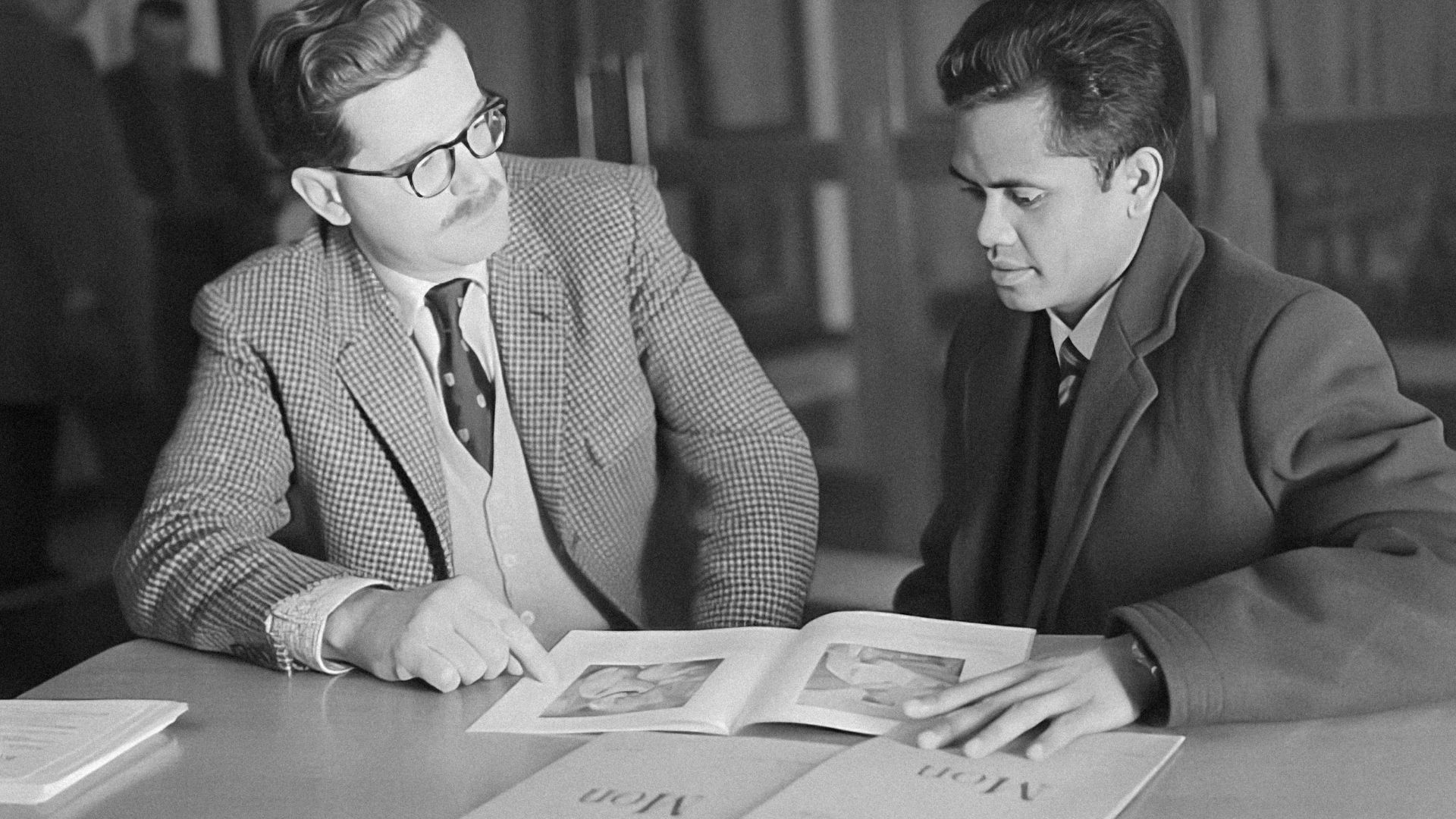 a couple of men sitting at a table