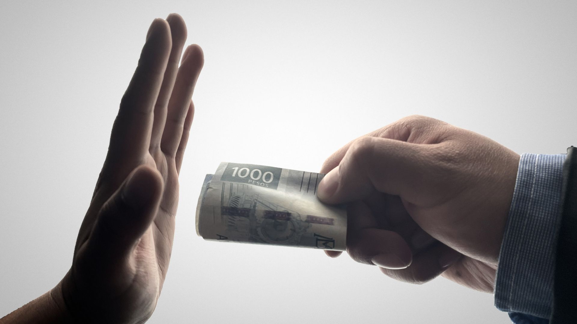 a person holding a stack of cash