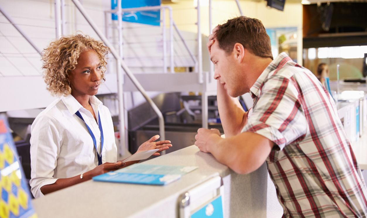 Shutterstock - 322320941 - Angry Passenger Complaining To Staff At Airport Check In.