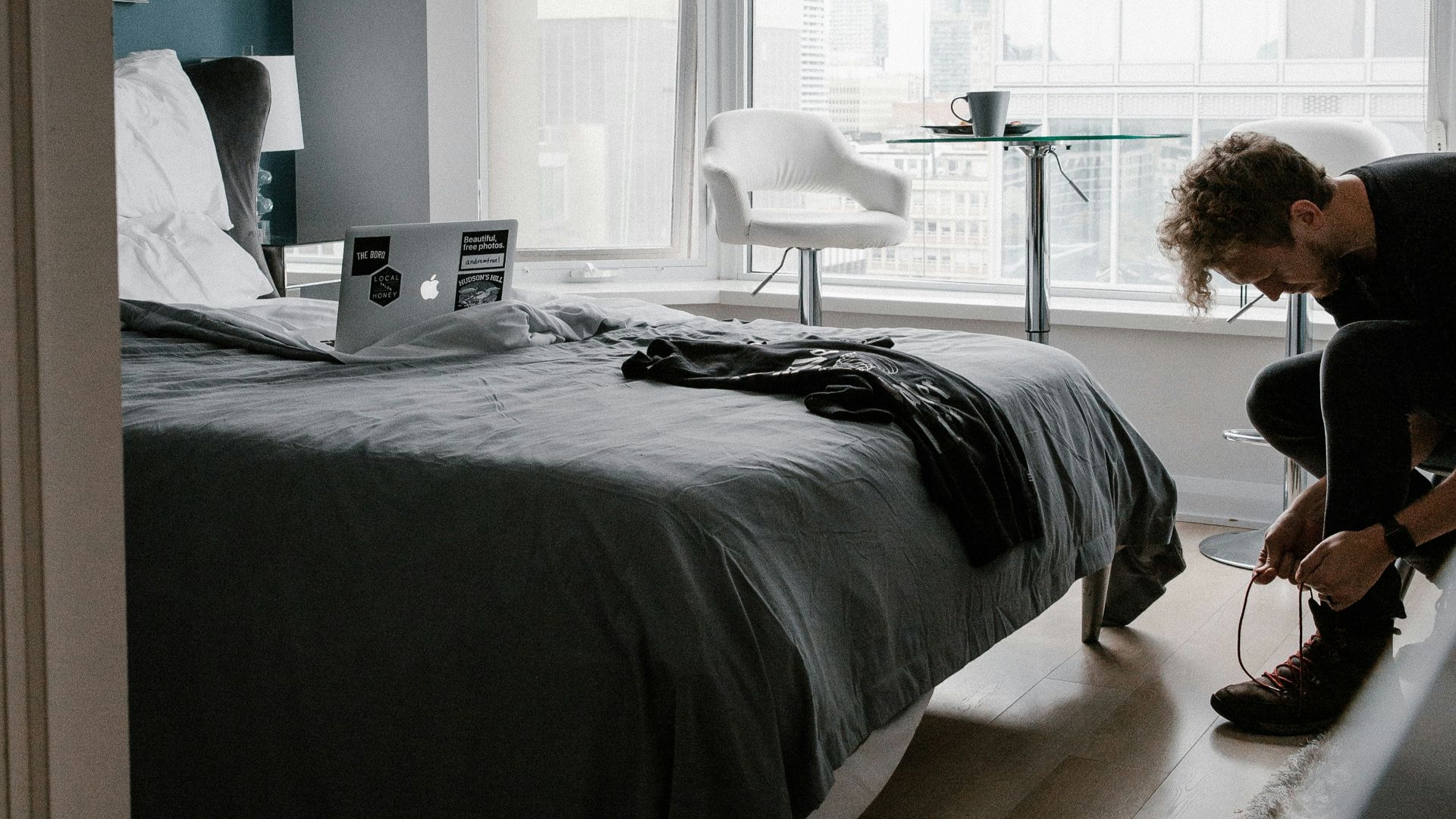 woman in black long sleeve shirt sitting on bed
