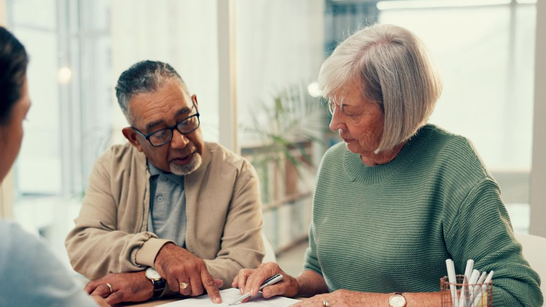 Talking, lawyer or old couple with will, contract or documents for life insurance papers or compliance. Plan, advisor or married elderly clients signing paperwork, legal form or title deed agreement